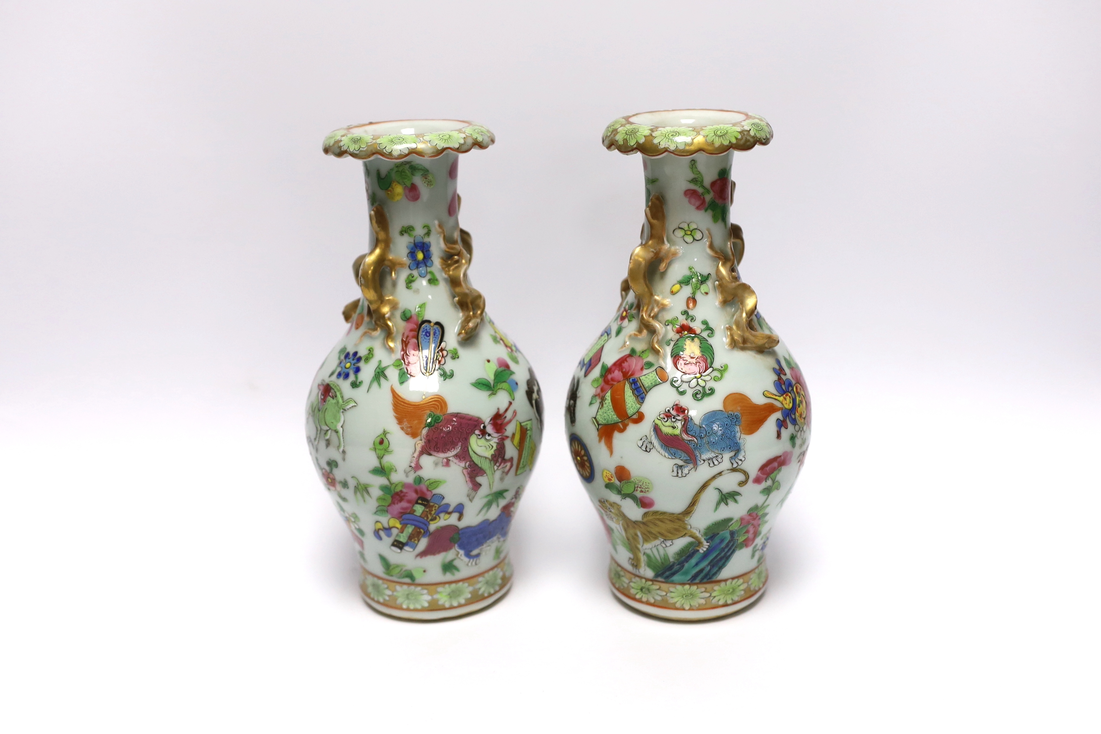 A pair of 19th century Chinese famille rose ‘mythical beasts’ vases, 24cm